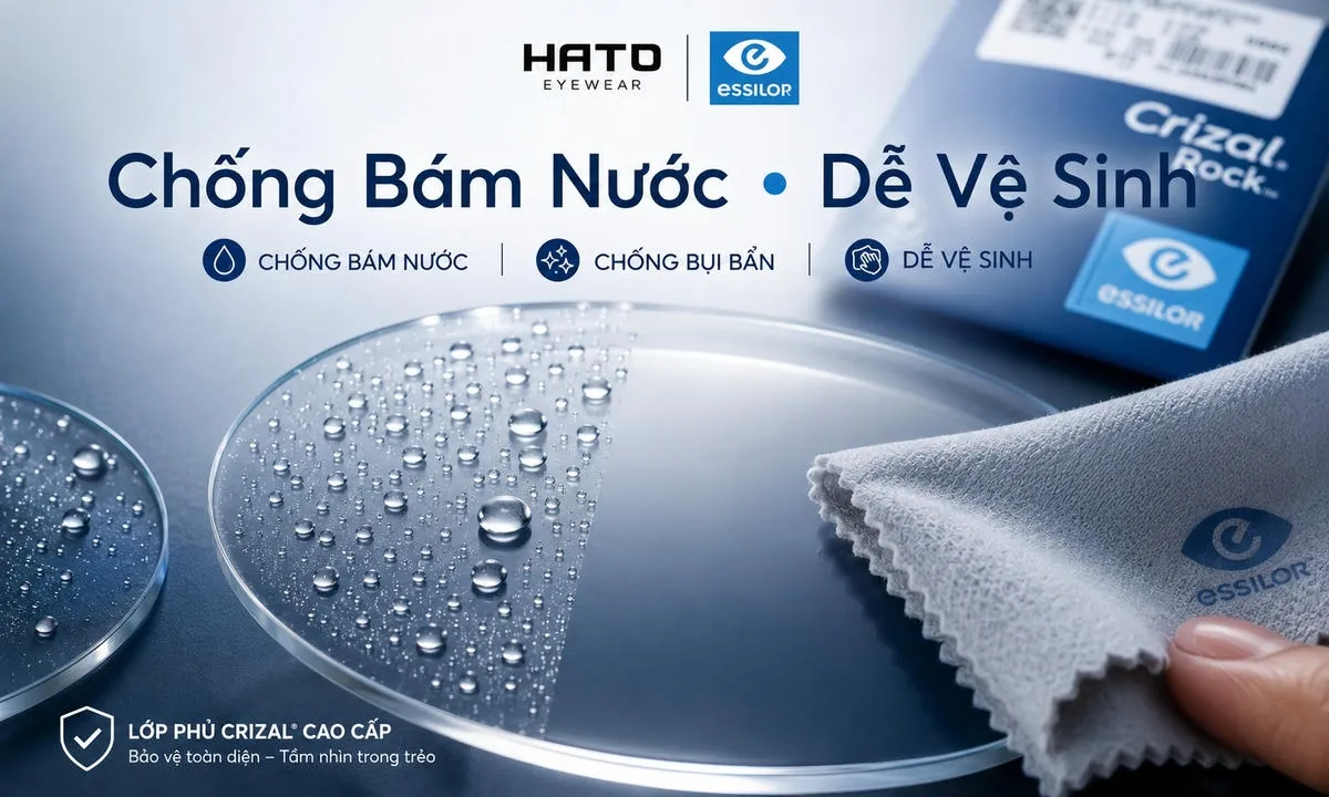 Ảnh minh họa tròng kính Essilor cao cấp với khả năng chống bám nước, hạn chế bụi bẩn và dễ vệ sinh. Bề mặt kính sạch bóng, giọt nước đọng thành hạt, phù hợp cho nội dung blog về lớp phủ bảo vệ tròng kính.