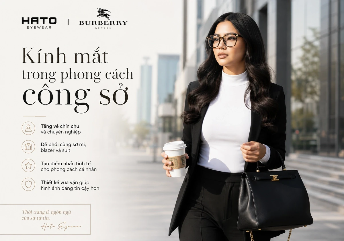 Người phụ nữ mặc suit công sở thanh lịch, đeo kính mắt Burberry và cầm túi xách, minh họa vai trò của kính mắt trong phong cách công sở hiện đại.
